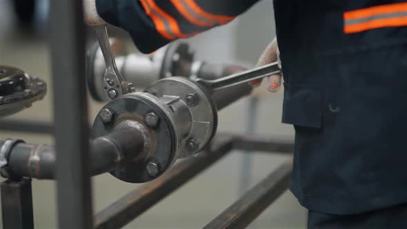 Closeup of a Hand with a Wrench Tighten the Nut