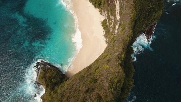 Rocky cliff with beach in the sea