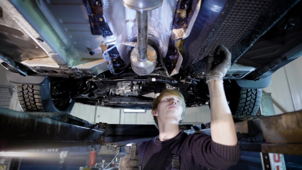 a Professional Mechanic Checks the Condition of Vehicles in a Tire Repair Shop