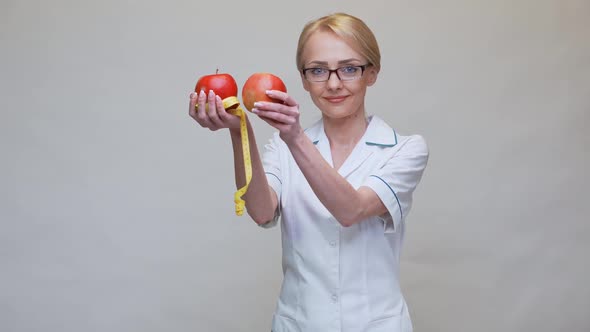 Nutritionist Doctor Healthy Lifestyle Concept - Holding Organic Red Apple and Measuring Tape