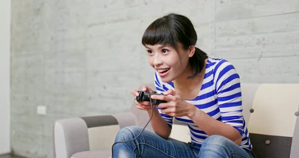 Woman play video game at home