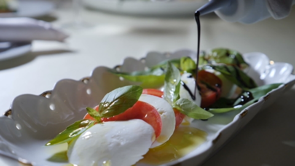 Healthy Food and Vegetarian Concept of Pouring Vinegar Over Caprese Salad Italian Caprese Sala