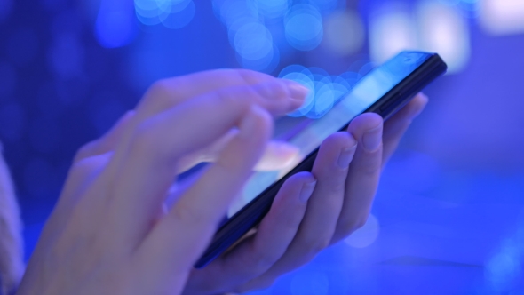 Young Woman Using Smartphone at Modern Technology Exhibition