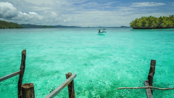 Blue Lagoon with Pure Clear Water and Clouds and Small Island in Background