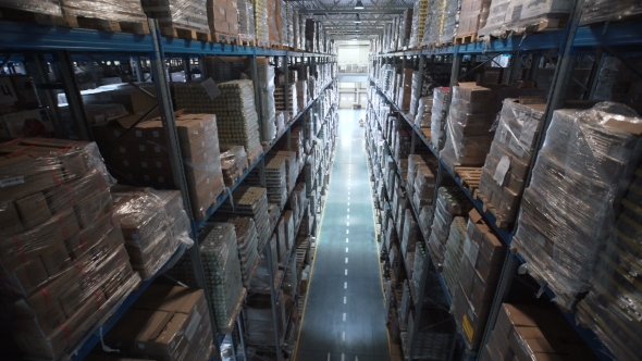 Camera Moves Up on Shelves of Cardboard Boxes Inside a Storage Warehouse