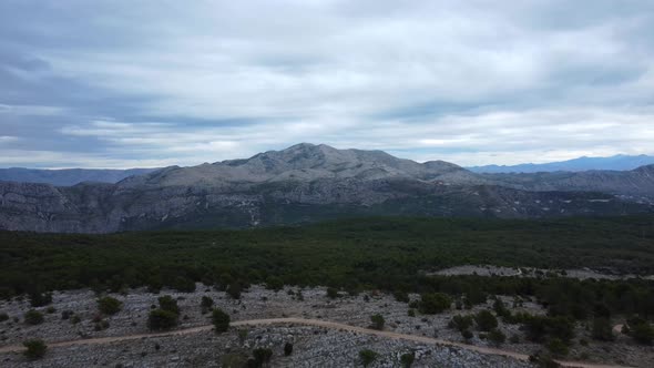 Beautiful aerial shot flying over a mountain range and hiking trail in Croatia