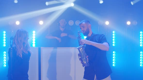 Musical Band Group of Vocalist Saxophonist Dj Playing Song Performing on Musician Concert Stage