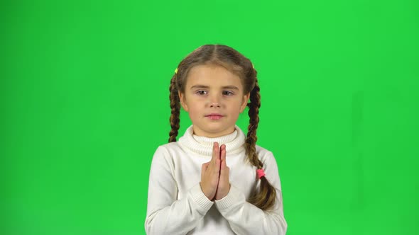 Lovely Girl Is Clapping Her Hands on Green Background