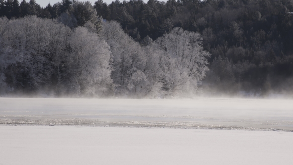  Fog Moving on a Half Frozen River with Frosty Trees