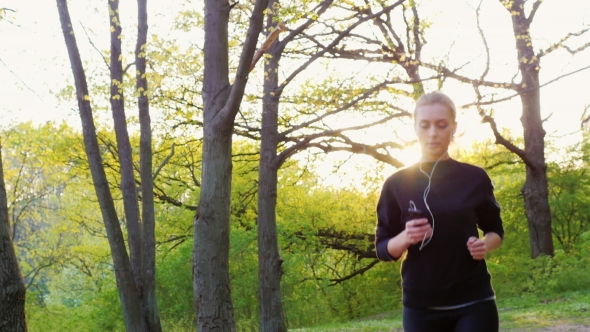 Steadicam  Shot: Young Woman Running in the Forest. Healthy Living and Sport