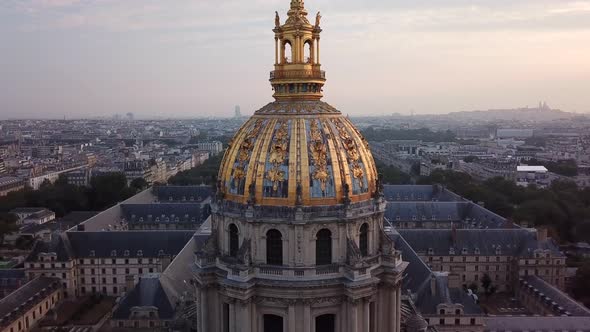 Aerialing: church with tall and gold decorated dome and wide cityscape in background, Les Invalides,