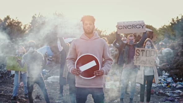 Portrait of Attractive Young Man Activist Holding Stop Sign