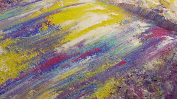 Artist Scraping Paint Powders In Colorful Patterns