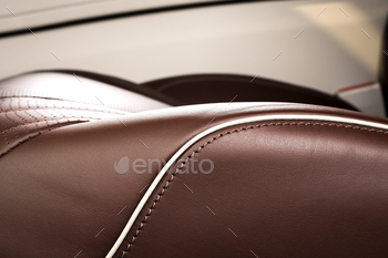 rior. Part of  leather car seat details with stitching.