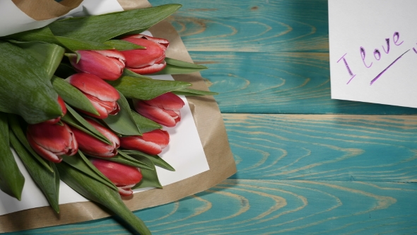 I Love You Message Note and Tulips Flowers Bouquet on a Wooden Table Couple