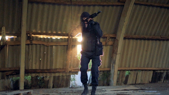  Armed Fighter Walks with an Automatic Rifle alt