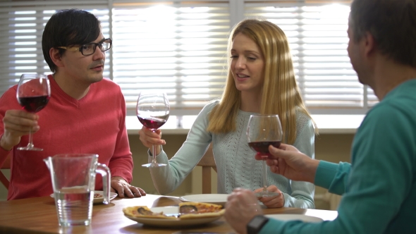 Three Friends Drinking Red Wine in the Restaurant