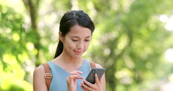 Woman use of mobile phone over the green background