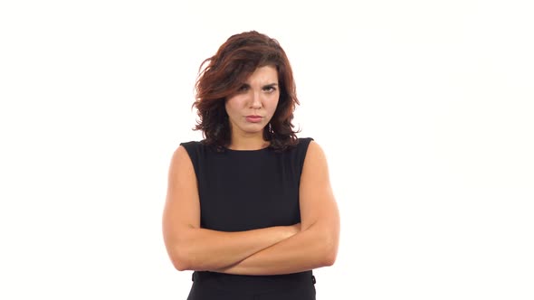 Displeased Upset Young Woman Crossing Her Arms and Looking in the Camera Isolated on White