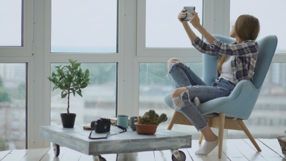 Young Happy Woman Have Online Video Chat Using Digital Tablet Computer Sitting on Balcony in Modern