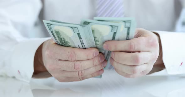 Businessman Counts Cash One Hundred Dollar Bills Closeup