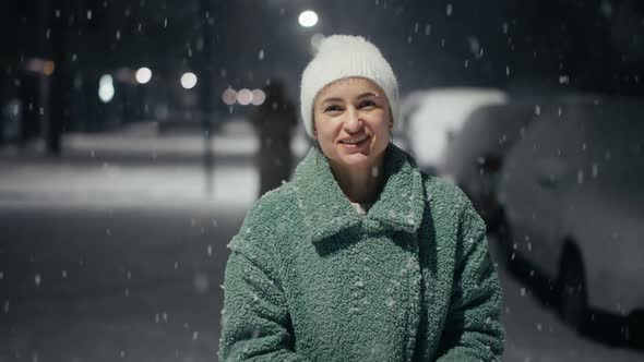 Cinematic Shot of Carefree Happy Smiling Young Woman Wearing Warm Hat is Excited and Amazed with