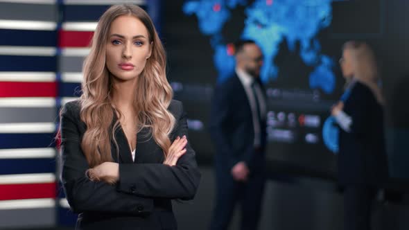 Confident Blonde Business Woman in Suit Posing with Crossed Hands at Modern Hi Tech Office