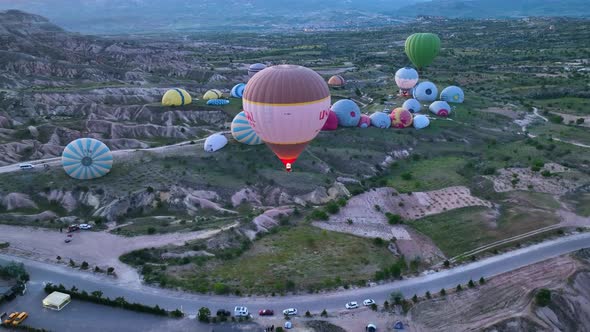 4K Aerial view of Goreme. Colorful hot air balloons fly over the valleys.