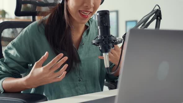 asia girl record a podcast with headphones and microphone look at camera  talk and take a rest