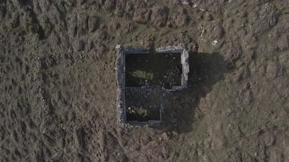 Top-Down View of Ruins Of Abandoned Irish Cottage In Wicklow Mountains In Ireland. - aerial