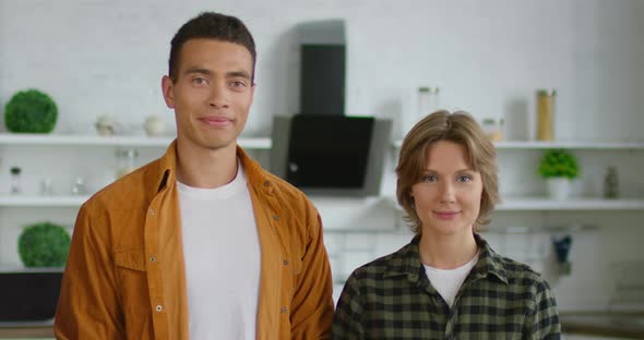 Portrait of Young Mixed Race Couple, Standing in Kitchen