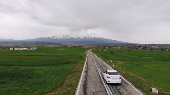 Aerial Drone View Electric Car Driving On Country Road