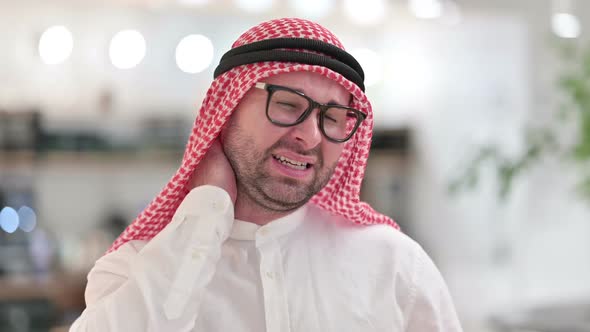 Stressed Young Arab Businessman Having Neck Pain