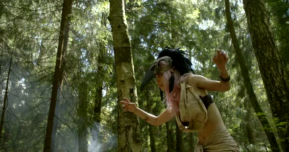 Woman Is Dancing Shamanic Ritual Dance in Forest Between Tall Pines