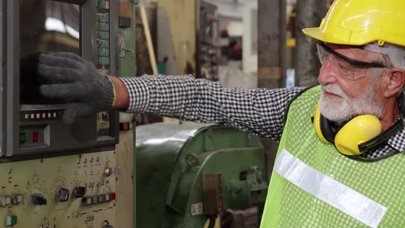 Senior Factory Worker Teach How to Use Machine Equipment in the Factory Workshop