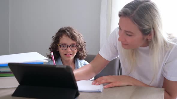 Mom and Small Son Eyeglasses Study Online on Laptop at Home Together Lesson Prepare Homework