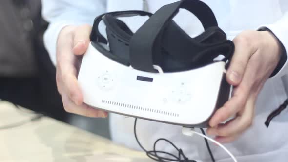 Man Looks at a Virtual Reality Helmet