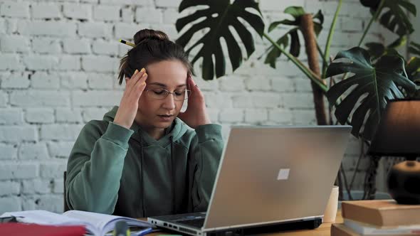 White Woman Struggling with Using Laptop at Home