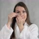 Young Woman Takes Care of Skin of Face - VideoHive Item for Sale