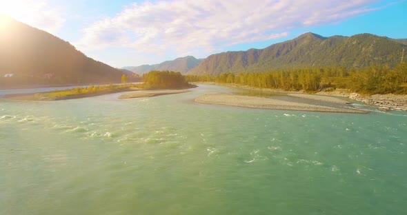 Low Altitude Flight Over Fresh Fast Mountain River with Rocks at Sunny Summer Morning