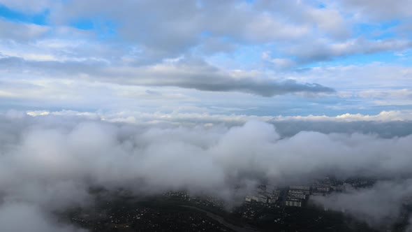 Aerial View From Airplane Window at High Altitude of Earth Covered with Puffy Cumulus Clouds Forming