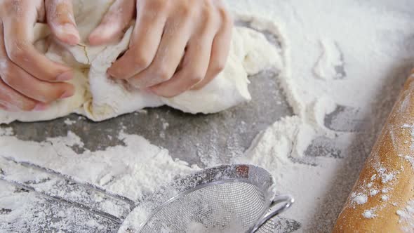 Woman kneading a dough