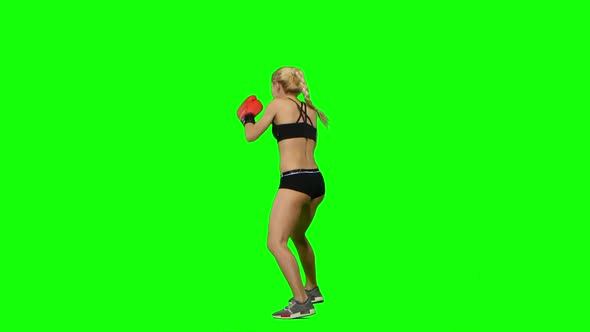 Boxer Standing in the Front and Make Swings and Kicks. Green Screen. Side View