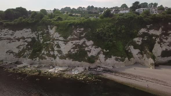 Rising aerial footage of Beer coastal cliffs, England.