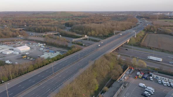 Vehicles Driving on a Motorway at Sunset Using The Junction and Bridges