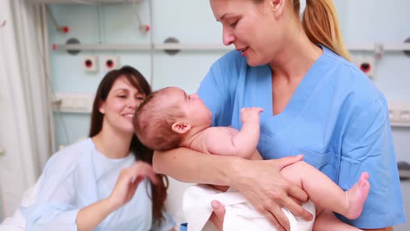 Nurse holding a new born baby