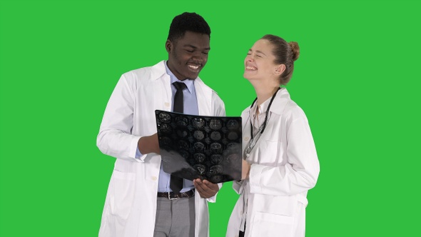 Laughing doctors studying X-ray on a Green Screen, Chroma Key.