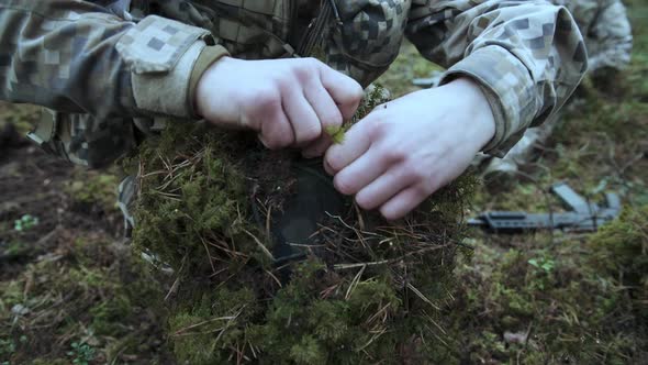 Soldier Make a Camouflage for a Helmet