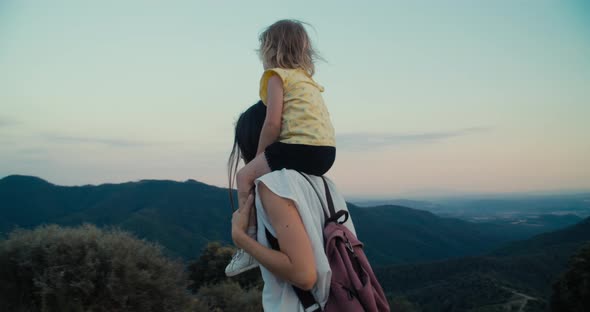 Family Exploring World Together Little Girl Sitting on Mother Neck on Hike Trip