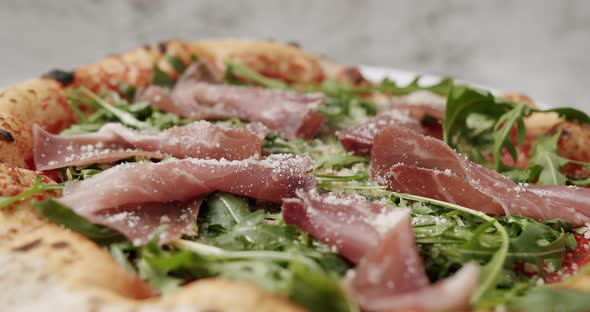 Close Up Pizza with Prosciutto Parma Ham Arugula Salad Rocket with Ingredients